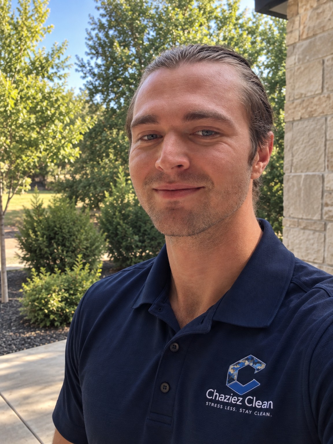 Chaz, founder of Chaziez Clean, wearing a navy Chaziez Clean polo